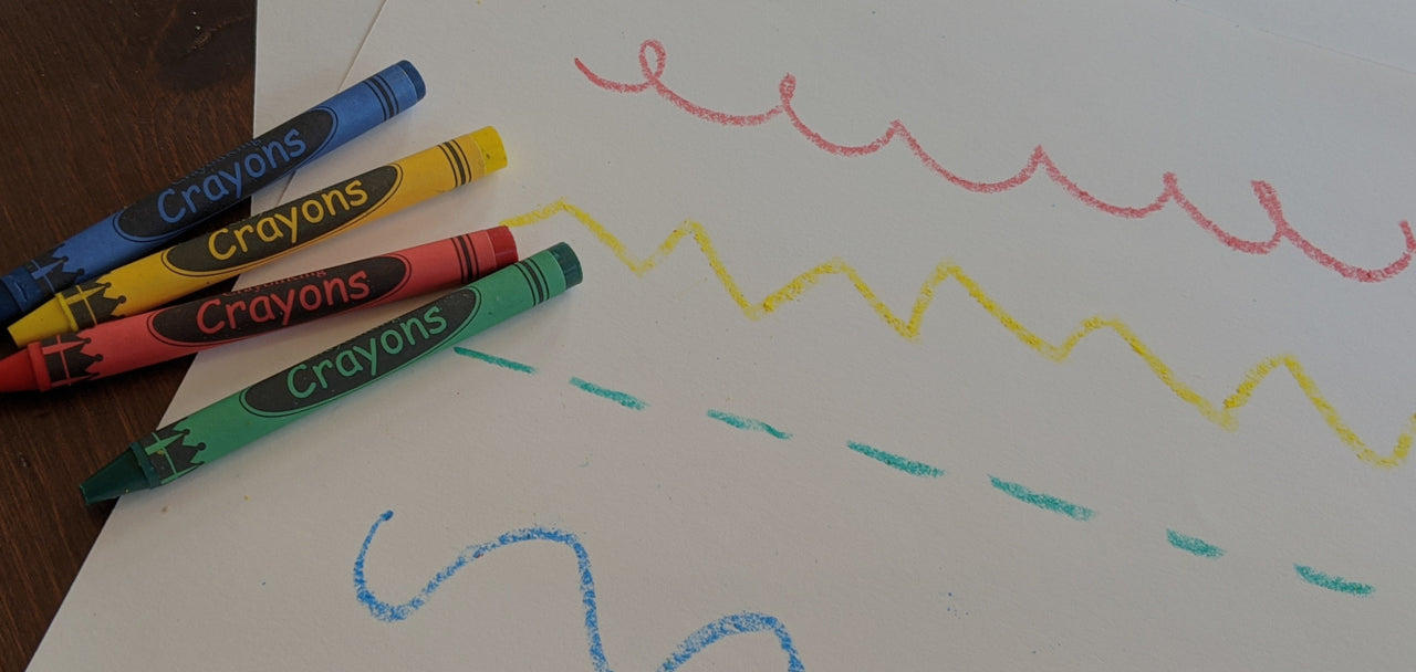 Photo showing red, green, blue, and yellow crayons.